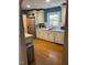 A galley kitchen with wooden floors, countertops, and stainless steel appliances at 1345 Ellis Rd, Durham, NC 27703