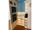Modern kitchen features stainless steel oven and microwave, white cabinetry, and brick wall at 1345 Ellis Rd, Durham, NC 27703