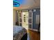 Bedroom view into en-suite bathroom with sliding glass doors and barn door style at 1345 Ellis Rd, Durham, NC 27703