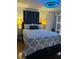 Comfortable bedroom with a queen bed and stylish blue ceiling fan at 1345 Ellis Rd, Durham, NC 27703