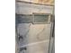 Up close look at tiled shower with built in storage and sleek shower fixtures at 1345 Ellis Rd, Durham, NC 27703