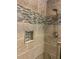 Close up of tiled shower with built-in shelves and modern shower head at 1345 Ellis Rd, Durham, NC 27703