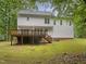 This home features a spacious wooden deck overlooking the lush backyard at 150 Remington Ct, Youngsville, NC 27596