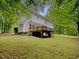 The backyard of this home features a spacious wooden deck overlooking the lush yard at 150 Remington Ct, Youngsville, NC 27596