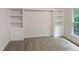 A view of the bedroom with built in cabinets, view to the outside, and carpet flooring at 150 Remington Ct, Youngsville, NC 27596