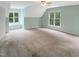 Large bedroom with natural light, ceiling fan, and neutral carpet at 150 Remington Ct, Youngsville, NC 27596