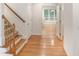 Inviting entryway with hardwood floors, staircase, and arched doorway leading to a bright living space at 150 Remington Ct, Youngsville, NC 27596