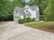 Charming two-story home with manicured landscaping, attached garage, and a concrete driveway at 150 Remington Ct, Youngsville, NC 27596