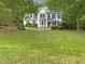 Charming two-story home with a manicured lawn and mature trees enhancing curb appeal at 150 Remington Ct, Youngsville, NC 27596