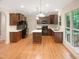 Well-equipped kitchen with stainless steel appliances, island, and beautiful wood floors at 150 Remington Ct, Youngsville, NC 27596