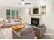 Bright and inviting living room with a cozy fireplace and built-in shelving at 150 Remington Ct, Youngsville, NC 27596
