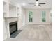 Cozy Living Room with built in cabinets, view to the outside and a fireplace at 150 Remington Ct, Youngsville, NC 27596
