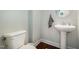 Half-bath features a stylish pedestal sink and toilet, offering a clean and functional space at 187 Ashley Woods Ct, Clayton, NC 27527