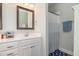 Inviting bathroom featuring a modern vanity, framed mirror, and a shower with a patterned curtain at 187 Ashley Woods Ct, Clayton, NC 27527