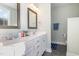 Bright bathroom featuring a double vanity with framed mirrors, drawers, and a separate toilet space at 187 Ashley Woods Ct, Clayton, NC 27527