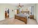 Comfortable bedroom features a large wooden bed frame, carpet, and a walk-in closet with hanging storage at 187 Ashley Woods Ct, Clayton, NC 27527