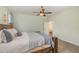 Spacious bedroom features a wooden bed frame, carpet, a ceiling fan, and a doorway to another room at 187 Ashley Woods Ct, Clayton, NC 27527