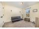Bright bedroom with a gray futon, neutral carpet, and a large window offering natural outdoor views at 187 Ashley Woods Ct, Clayton, NC 27527