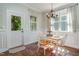 Charming dining area with white wainscotting, wooden floors, and a view to the backyard at 187 Ashley Woods Ct, Clayton, NC 27527