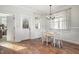 Bright dining room with hardwood floors, stylish lighting, and a door to the outside at 187 Ashley Woods Ct, Clayton, NC 27527