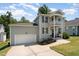 Well-maintained two-story home with a front-facing two-story porch and attached garage at 187 Ashley Woods Ct, Clayton, NC 27527