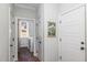 Hallway area with access to the laundry room with a full-size washer and dryer at 187 Ashley Woods Ct, Clayton, NC 27527