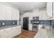 Beautiful kitchen with white cabinets, stainless steel appliances, and sleek countertops at 187 Ashley Woods Ct, Clayton, NC 27527