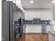 Modern kitchen featuring stainless steel appliances, granite countertops, and stylish backsplash at 187 Ashley Woods Ct, Clayton, NC 27527