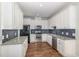 Modern kitchen with white cabinetry, stainless steel appliances, and granite countertops at 187 Ashley Woods Ct, Clayton, NC 27527