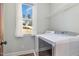 Bright laundry room with a window and a white washer and dryer at 187 Ashley Woods Ct, Clayton, NC 27527