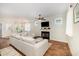 Cozy living area featuring a fireplace, ceiling fan, and ample natural light at 187 Ashley Woods Ct, Clayton, NC 27527