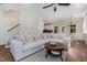 Cozy living room featuring a plush sectional sofa, hardwood floors, and an inviting dining area at 187 Ashley Woods Ct, Clayton, NC 27527