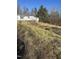 Modest single story house with wooded surroundings at 1916 E Hughes Mill Rd, Burlington, NC 27217