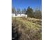 Modest single story house with wooded surroundings at 1916 E Hughes Mill Rd, Burlington, NC 27217