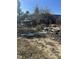 View of debris and junk vehicle covered in brush at 1916 E Hughes Mill Rd, Burlington, NC 27217