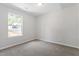 Cozy bedroom with neutral walls, carpeting, and a large window at 20 Meadowcrest Dr, Durham, NC 27703