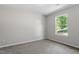 Carpeted bedroom featuring a bright window with nature view at 20 Meadowcrest Dr, Durham, NC 27703