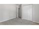 Cozy bedroom featuring neutral carpeting and closet space at 20 Meadowcrest Dr, Durham, NC 27703