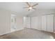 Spacious bedroom featuring carpeting, a ceiling fan, and large closets at 20 Meadowcrest Dr, Durham, NC 27703