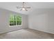 Bright bedroom with a large window showcasing natural outdoor scenery at 20 Meadowcrest Dr, Durham, NC 27703