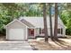 Charming one-story home with gray siding, a red front door, and an attached garage at 20 Meadowcrest Dr, Durham, NC 27703
