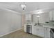Elegant kitchen featuring stainless steel appliances, white cabinets, and marble countertops at 20 Meadowcrest Dr, Durham, NC 27703