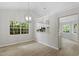 Bright living area with hardwood floors, light gray walls, and open access to the eat-in kitchen at 20 Meadowcrest Dr, Durham, NC 27703