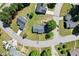An aerial view shows a home with a manicured lawn in a quiet neighborhood with mature trees at 203 Marlowe Dr, Dunn, NC 28334