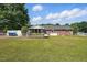 Spacious backyard with a ramp, lawn, white fencing, and rear exterior view of home at 203 Marlowe Dr, Dunn, NC 28334