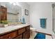 Well-lit bathroom with granite counters, wooden cabinets, a glass shower, and a modern toilet at 203 Marlowe Dr, Dunn, NC 28334