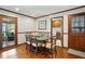 Dining room with hardwood floors and wood trim, featuring doors leading to the outside and laundry room at 203 Marlowe Dr, Dunn, NC 28334