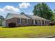 Charming brick home with a lush front yard, white columns and black shutters at 203 Marlowe Dr, Dunn, NC 28334