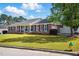 Charming brick home with a lush front yard, white columns and black shutters at 203 Marlowe Dr, Dunn, NC 28334