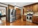 Kitchen with stainless steel refrigerator, gas range, granite countertops, and hardwood floors at 203 Marlowe Dr, Dunn, NC 28334